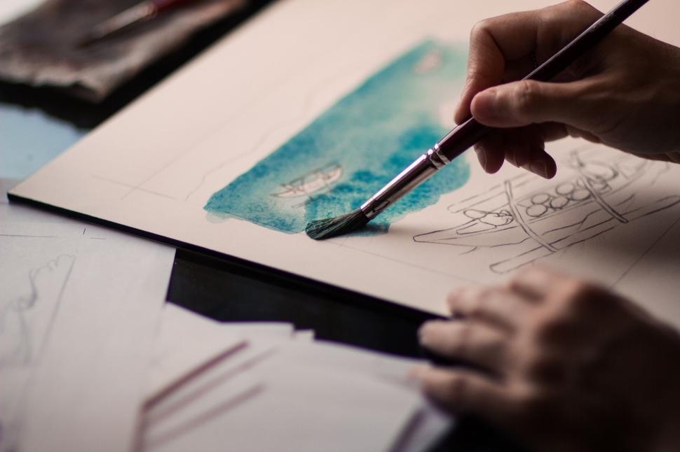 Free Image of Person Drawing on Piece of Paper 