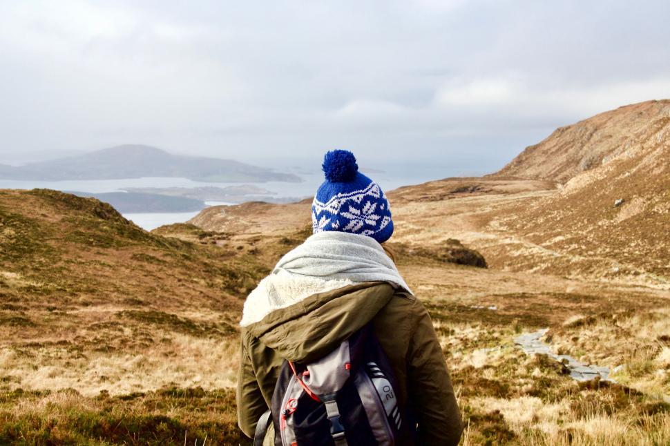 Free Image of Person Wearing Blue Hat and Carrying Backpack 