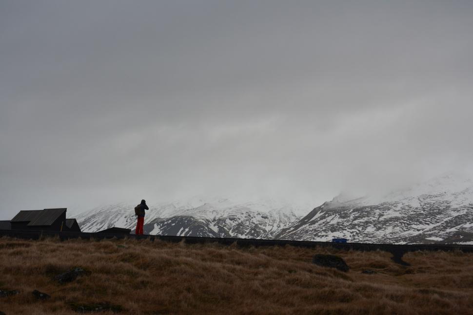 Free Image of Man Standing on Grass Covered Hillside 