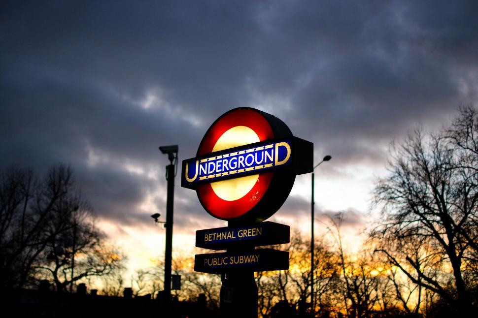 Free Image of Red and White Sign Under Cloudy Sky 