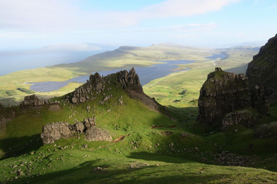Free Image of Grassy Hill Overlooking Distant Lake 