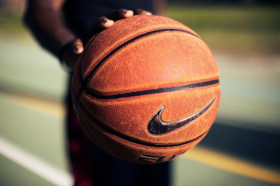 Free Image of Person Holding Basketball on Court 