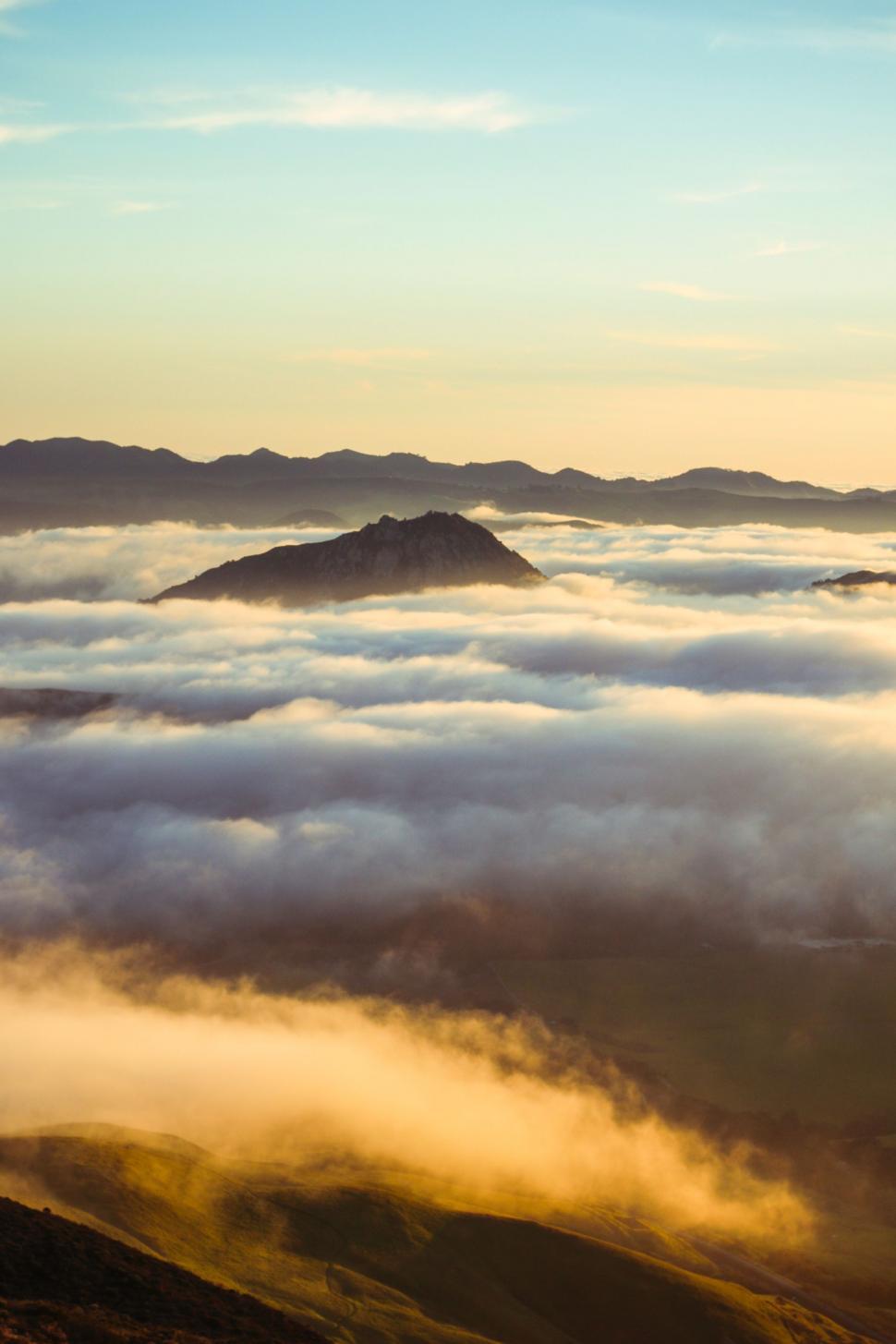 Free Image of Clouds Enveloping Mountain Summit 