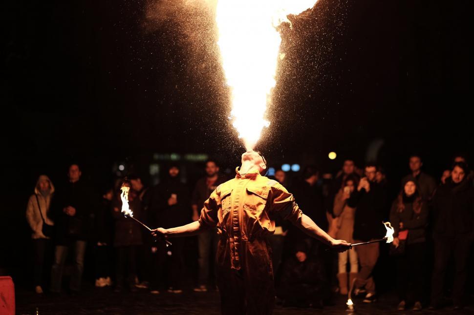 Free Image of Man Standing in Front of Large Fire 