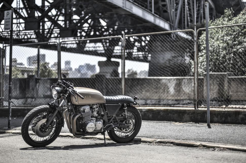 Free Image of Motorcycle Parked in Front of Bridge 