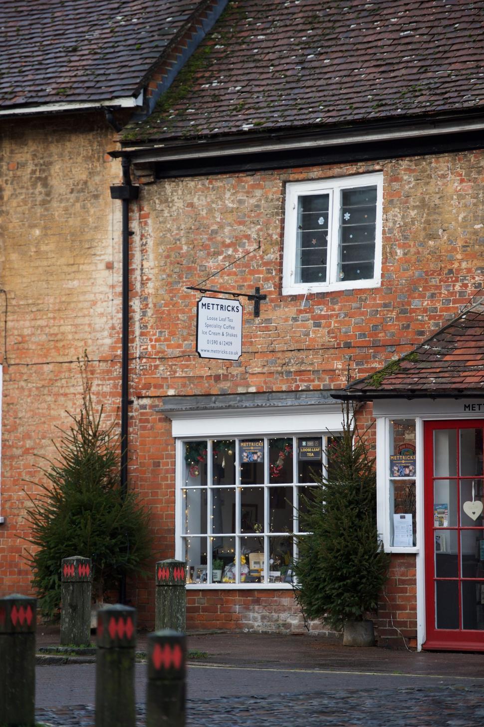 Free Image of Brick Building With Red Door and Windows 