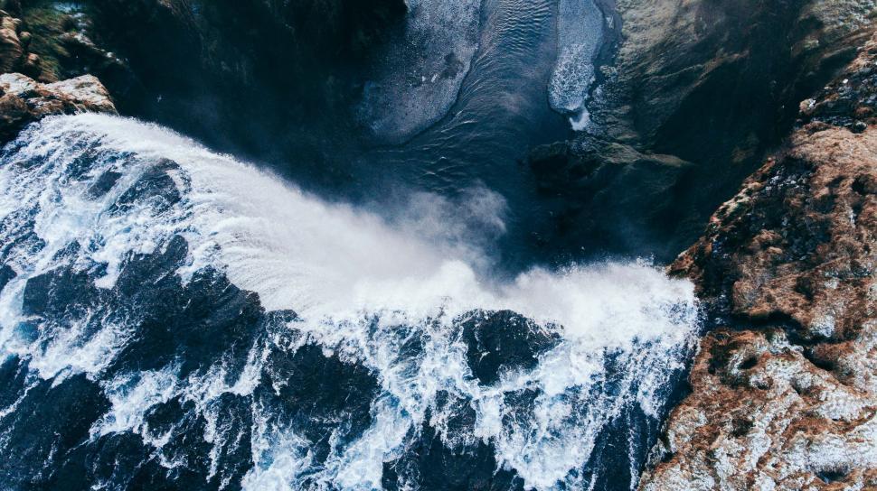 Free Image of Rocky Shoreline Surrounding Large Body of Water 