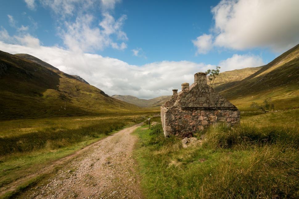 Free Image of Stone Building Alongside Dirt Road 