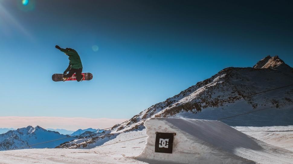 Free Image of Man Flying Through the Air on Snowboard 