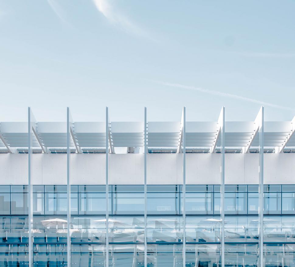 Free Image of Modern Building Facade With Numerous Windows Against Sky Background 