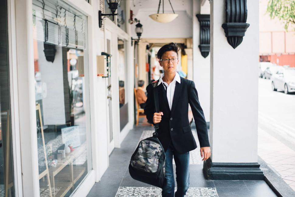 Free Image of Businessman Walking Down the Street 
