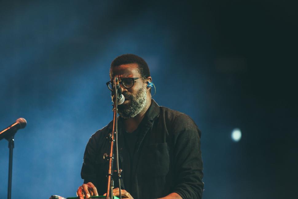 Free Image of Man Playing Musical Instrument in Front of Microphone 
