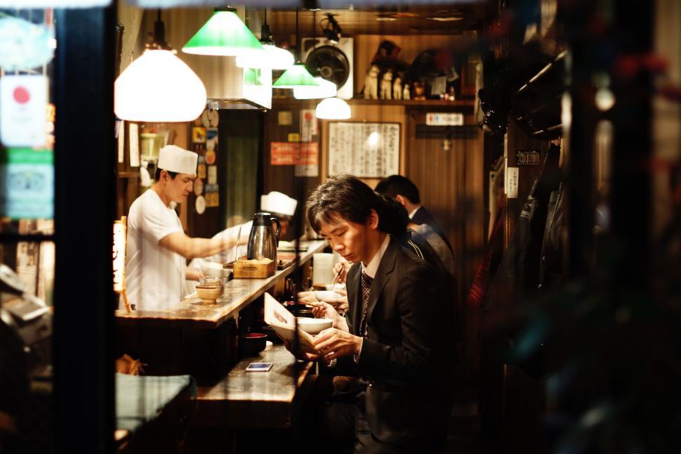 Free Image of Man Standing at Counter in Restaurant 