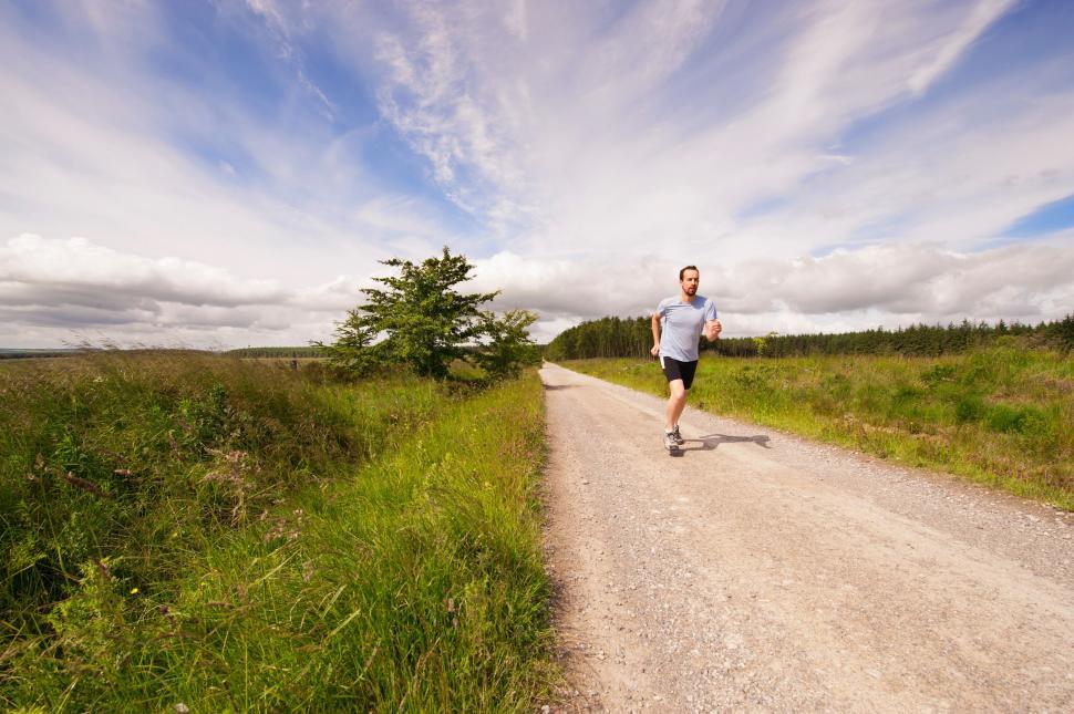 Free Image of Man Running Down Dirt Road 