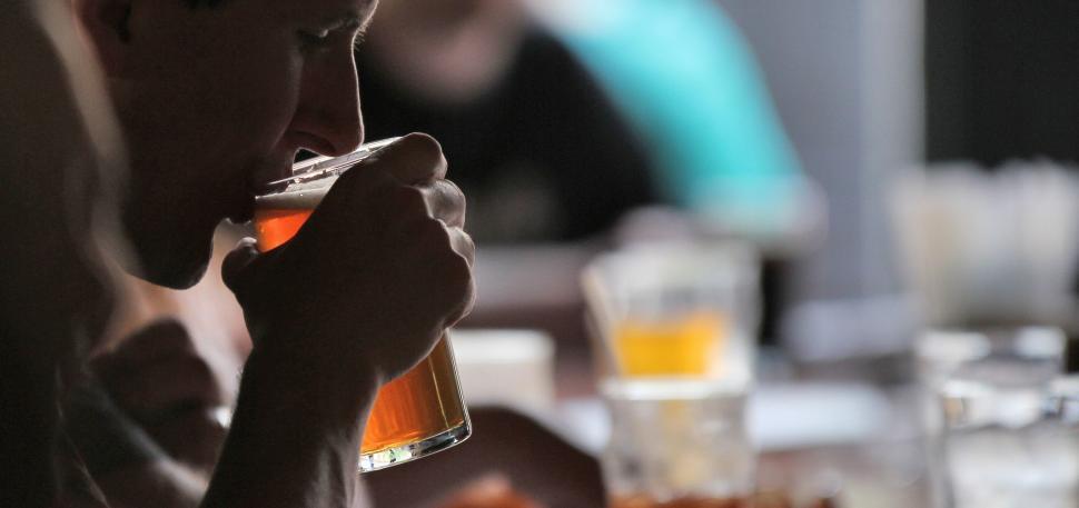 Free Image of Man Sitting at Table With a Drink 