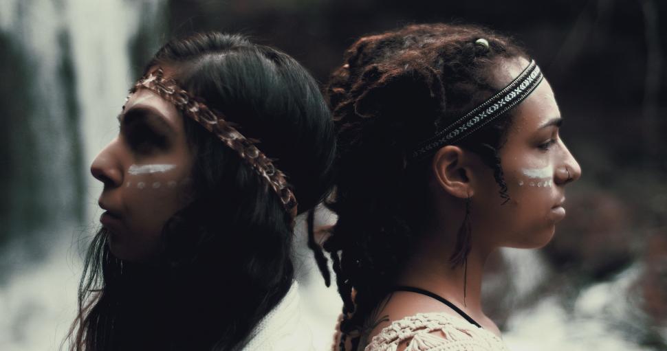 Free Image of Two Women With White Paint on Their Faces 