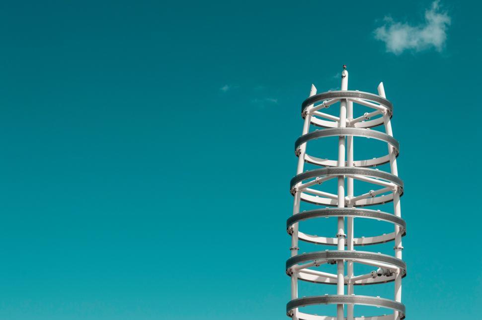 Free Image of Tall Metal Structure on Lush Green Field 