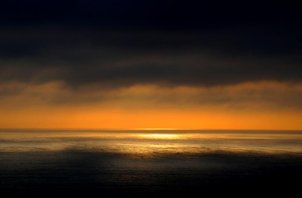 Free Image of Large Body of Water Under Cloudy Sky 