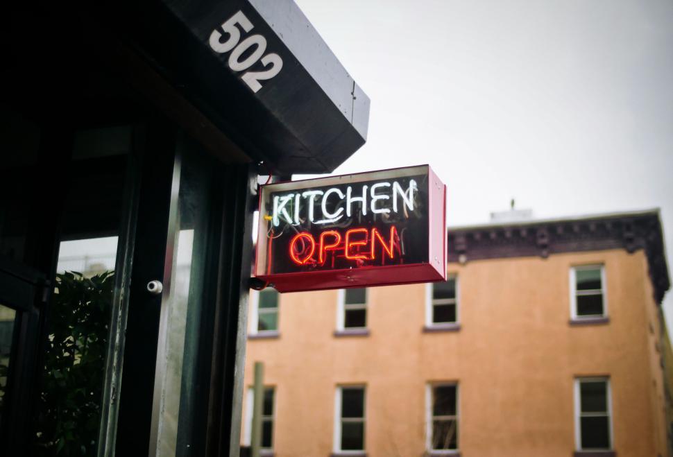 Free Image of Kitchen Open Sign on Side of Building 