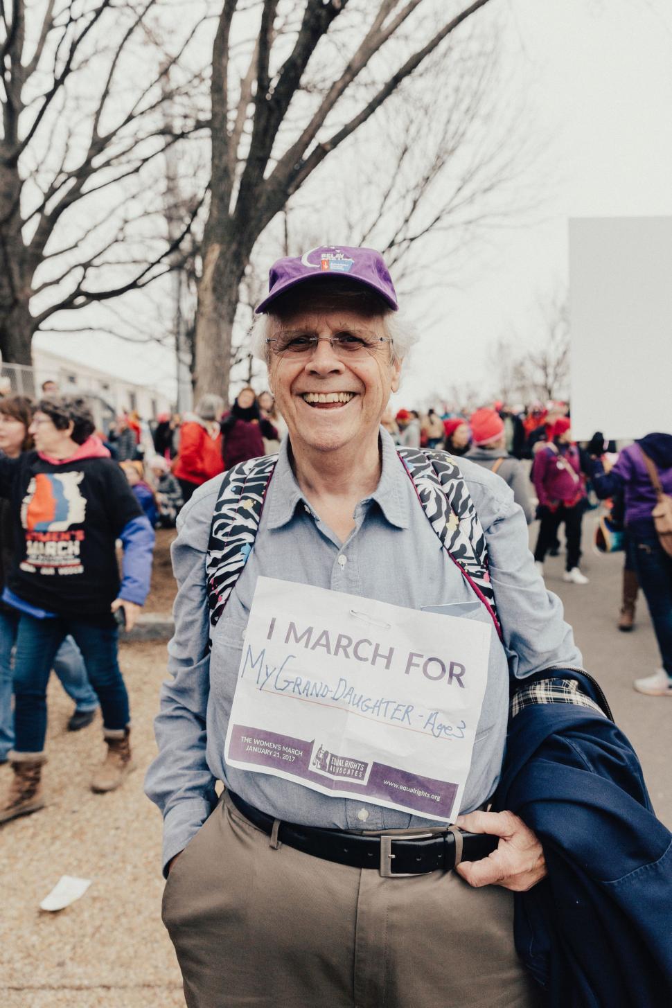 Free Image of Man Holding Sign in Front of Crowd 