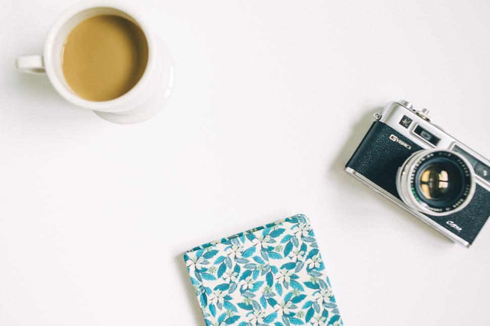 Free Image of Coffee Cup, Camera, and Napkin on Table 