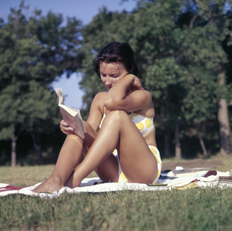 Free Image of Woman Sitting on Blanket Reading Book 