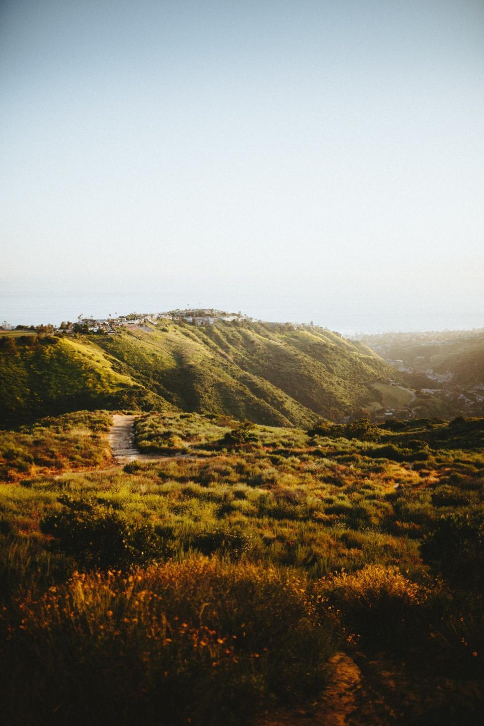 Free Image of Grassy Hill With Stream Running Through 