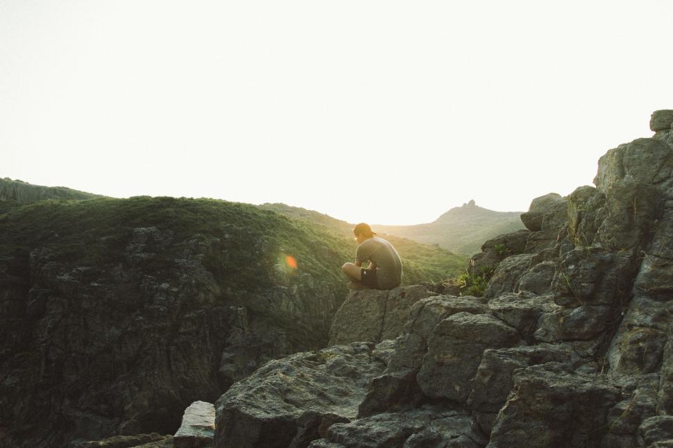Free Image of Man Standing on Top of Rocky Mountain 
