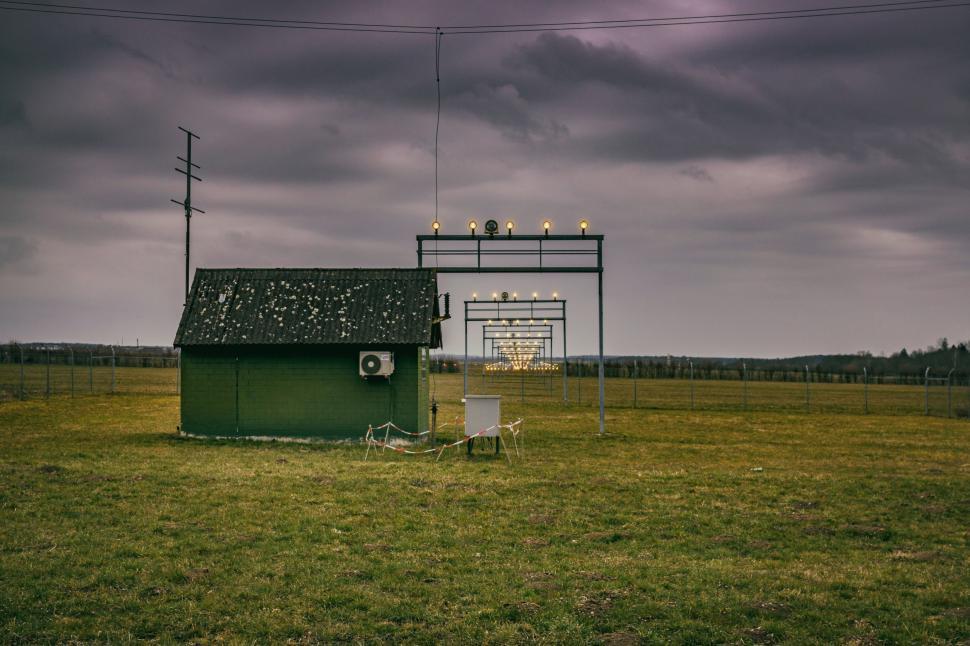 Free Image of Green Building on Top of Lush Green Field 