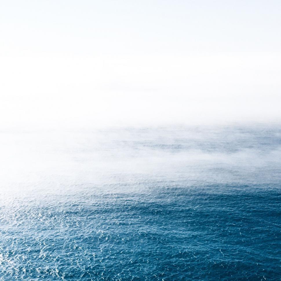 Free Image of Large Body of Water Under Cloudy Sky 