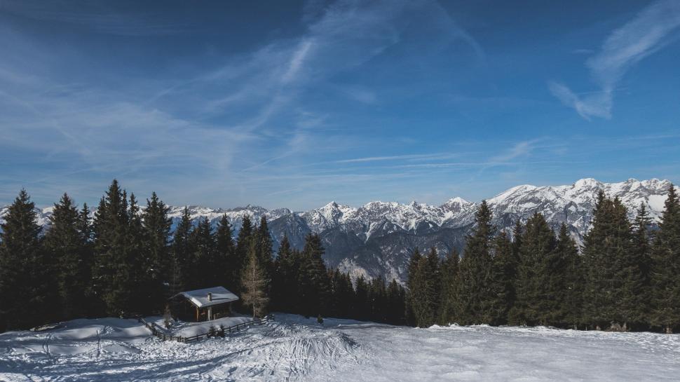 Free Image of Snow Covered Hill With Distant House 
