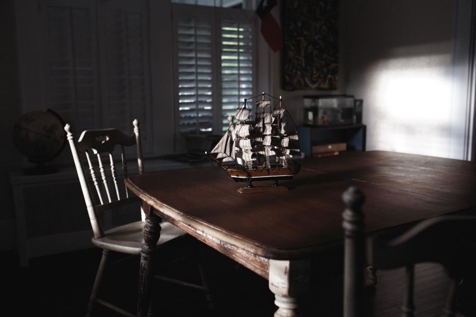 Free Image of Wooden Table With Two Chairs and a Vase 
