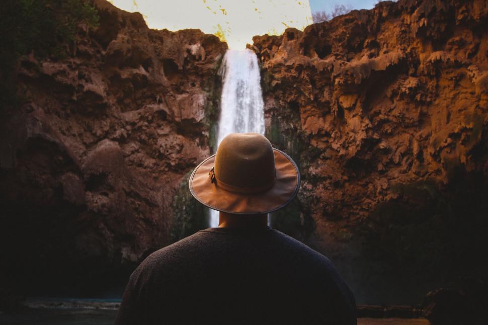 Free Image of Person Standing in Front of Waterfall 