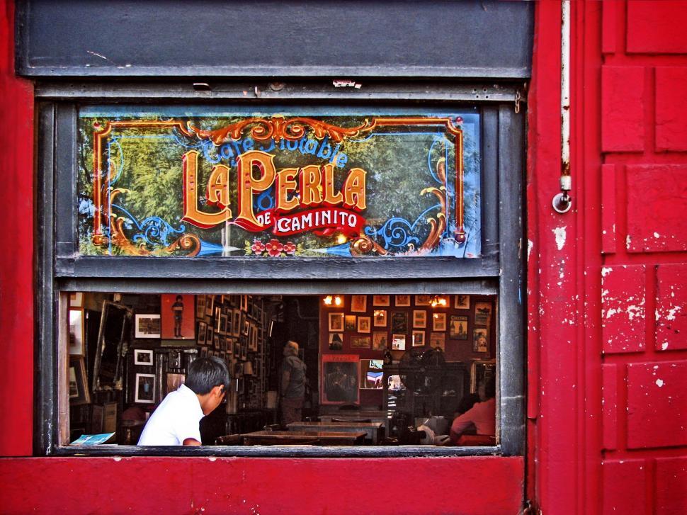 Free Image of Man Sitting in Restaurant Window 