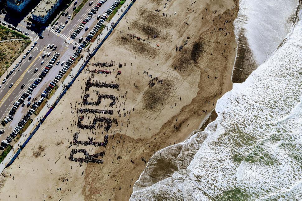 Free Image of Aerial View of Beach With Cars Parked 