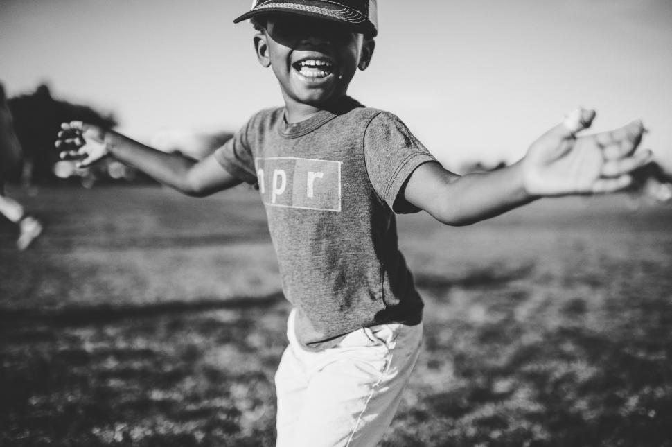 Free Image of Young Boy Wearing Hat Holding Baseball Glove 
