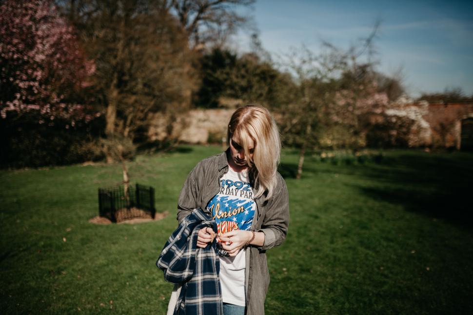 Free Image of Woman Holding Book in Field 
