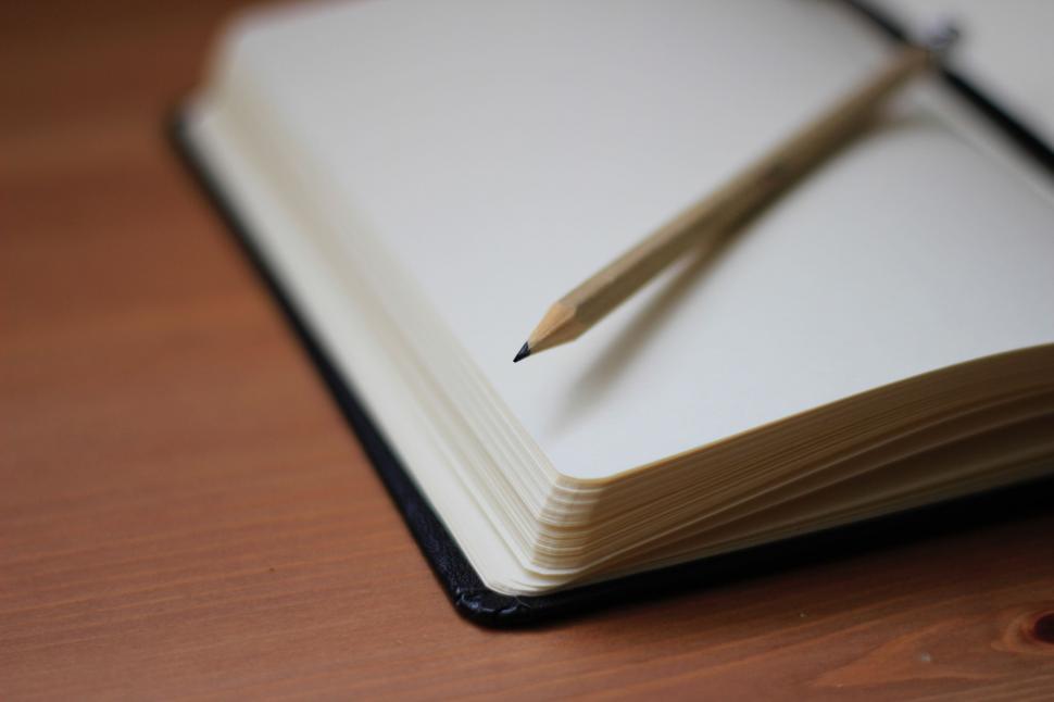 Free Image of Book With Pen Resting on Top 