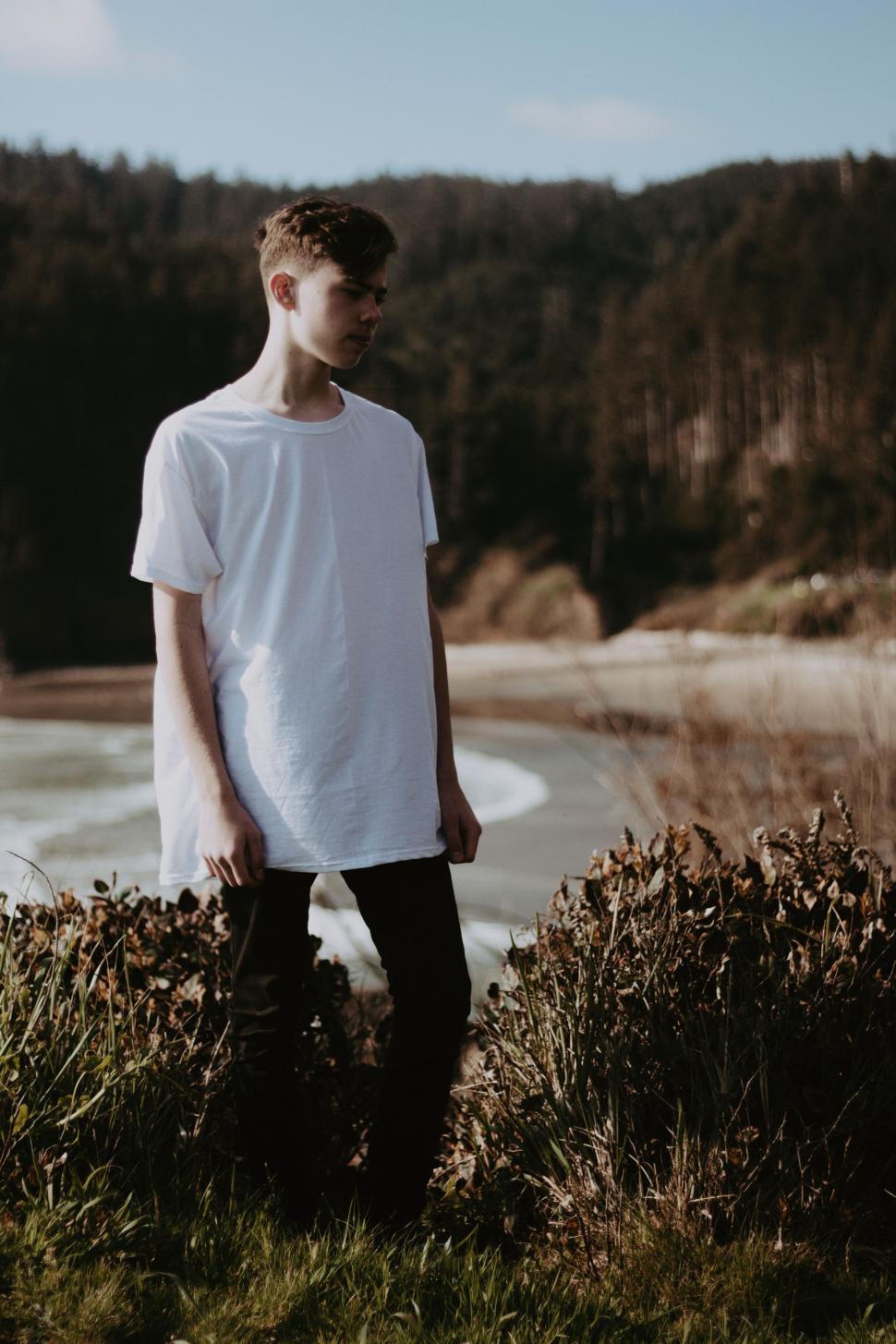 Free Image of Man Standing Next to Water in Field 