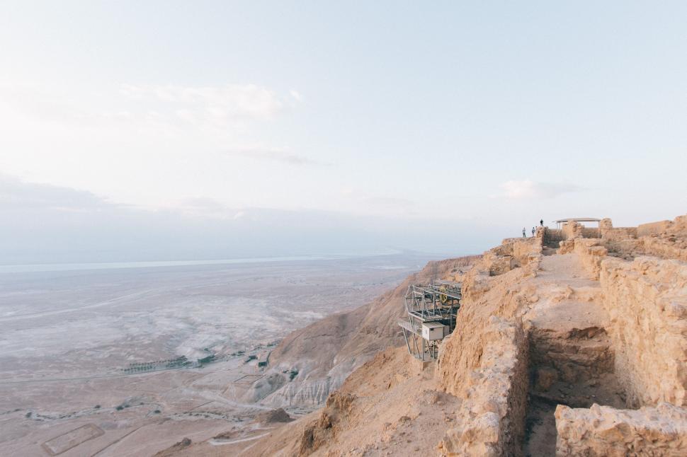Free Image of Group of People Standing on Top of a Cliff 