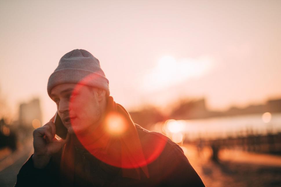 Free Image of Man Talking on Cell Phone Wearing Beanie 