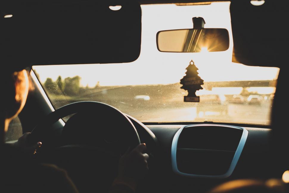Free Image of Person Driving Car With Christmas Tree on Dashboard 