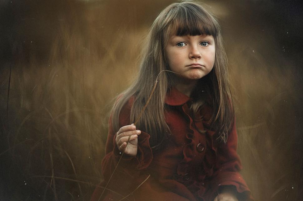 Free Image of Young Girl With Long Hair Holding a String 