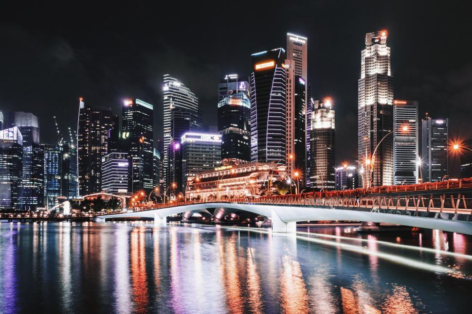 Free Image of City Skyline at Night With Lights Reflecting in Water 