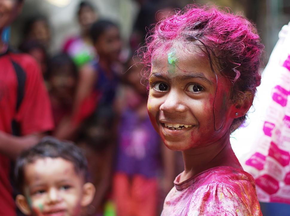 Free Image of Young Girl With Pink Hair Smiles at Camera 