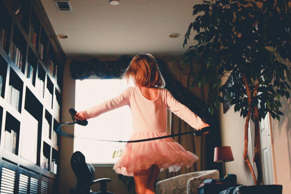 Free Image of Little Girl in Pink Dress Holding Sword 