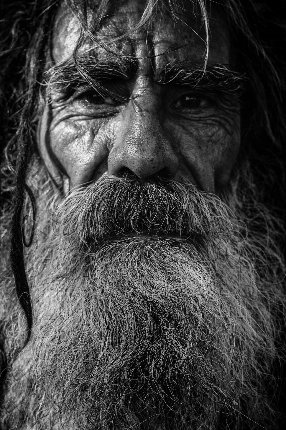 Free Image of Man With Long Beard Standing in Black and White 