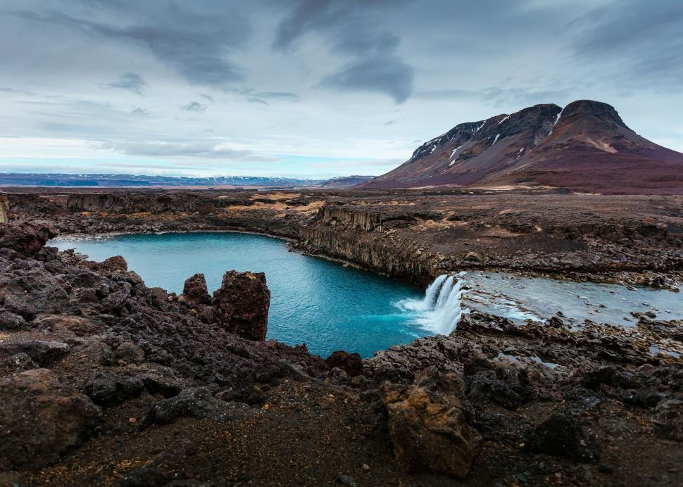 Free Image of Rocky Terrain Surrounding Large Body of Water 