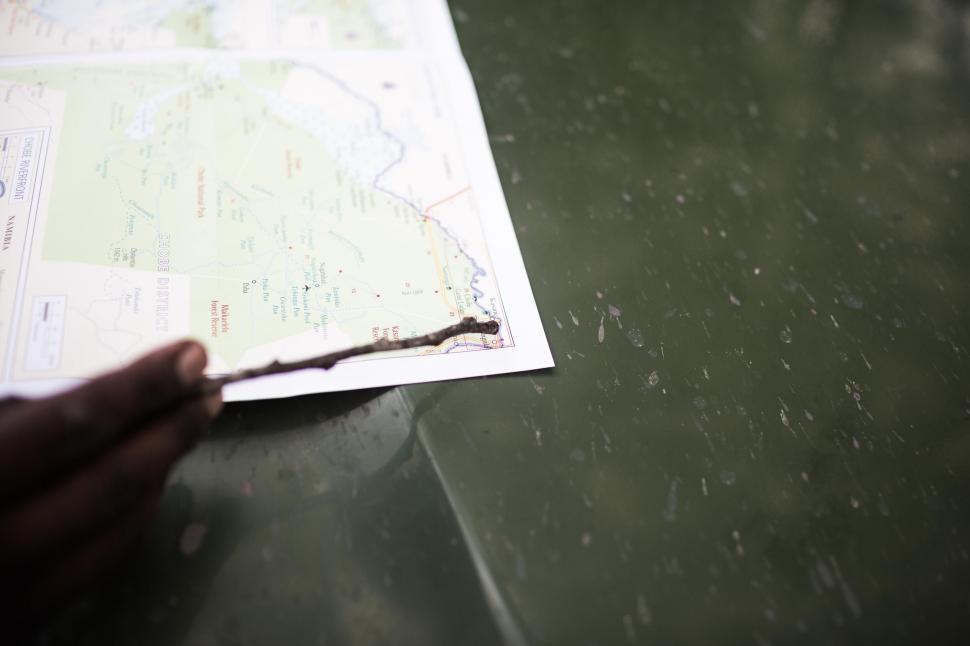 Free Image of Person Holding Piece of Paper on Table 