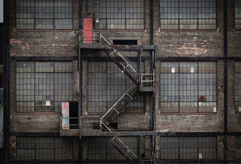 Free Image of Black and White Building With Red Door 